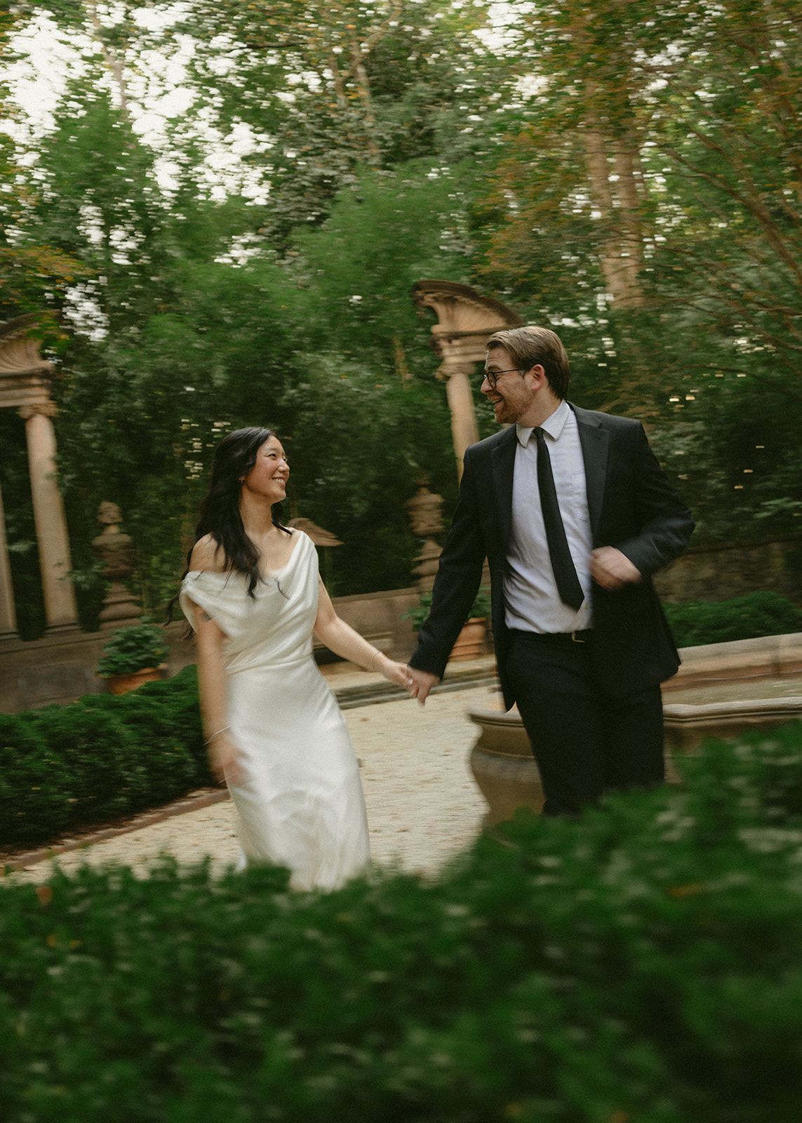 Rachel and Jack laughing as they walk through the garden