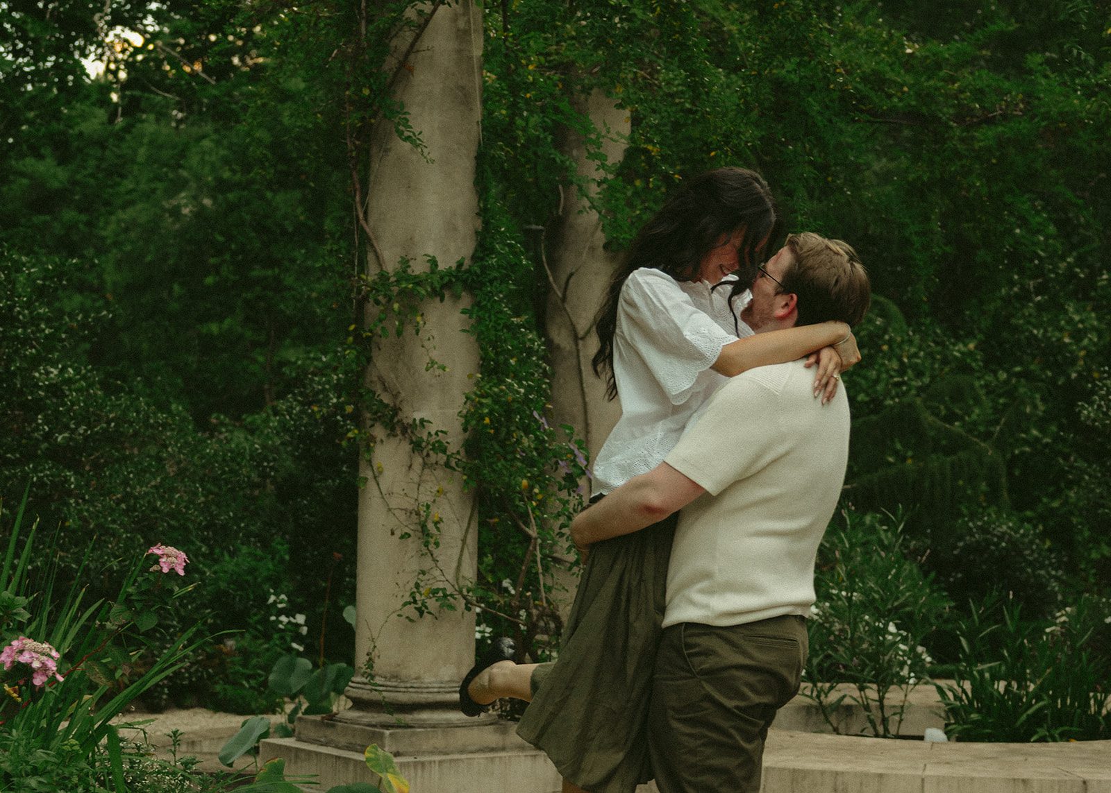 Jack lifting Rachel among ivy-covered stone columns
